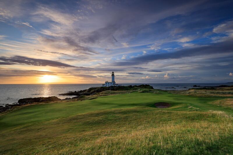 A view of the green on the par 3, ninth hole beside The Turnberry Lighthouse as sunset on the Ailsa golf course at Trump Turnberry resort