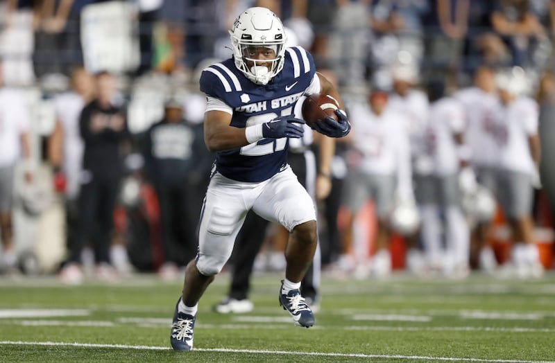 Hershel Turner Jr., #21 of the Utah State Aggies rushes the ball
