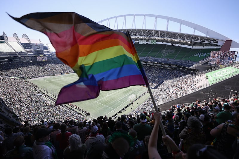 SEATTLE, WASHINGTON - JUNE 03: A fan waves a Pride flag before the game between the Seattle Sounders and the Portland Timbers at Lumen Field on June 03, 2023 in Seattle, Washington. (Photo by Steph Chambers/Getty Images)