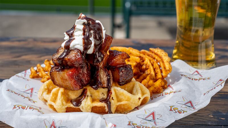 The Hogfather, an open-faced Belgian waffle covered in sweet and spicy pork burnt ends and finished with chocolate whipped cream (and costing $14). Crispy sweet potato waffle fries are served on the side.