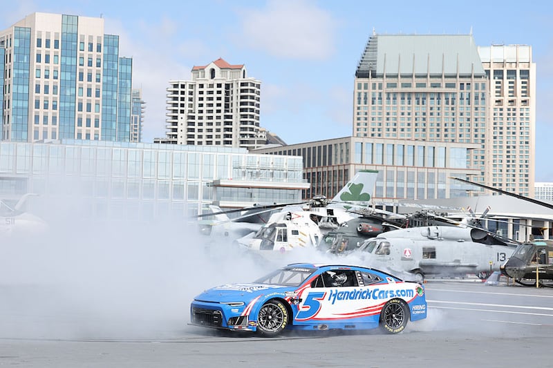Kyle Larson burns out on the deck of the USS Midway at the NASCAR Announcement at USS Midway Museum