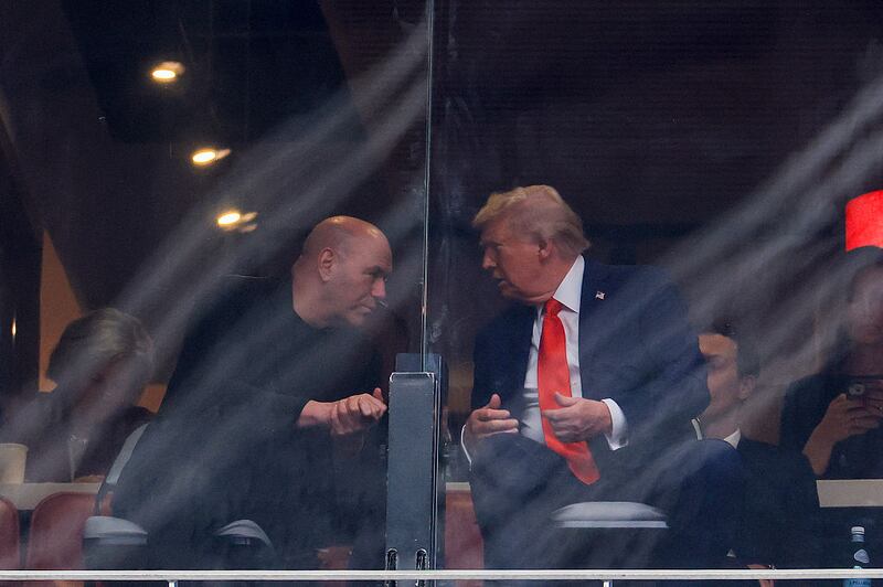 UFC CEO Dana White (L) speaks with U.S. President Donald Trump at the memorial service for political activist Charlie Kirk
