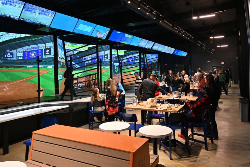 Visitors eat, drink and swing at the Home Run Dugout location in Katy, Texas.