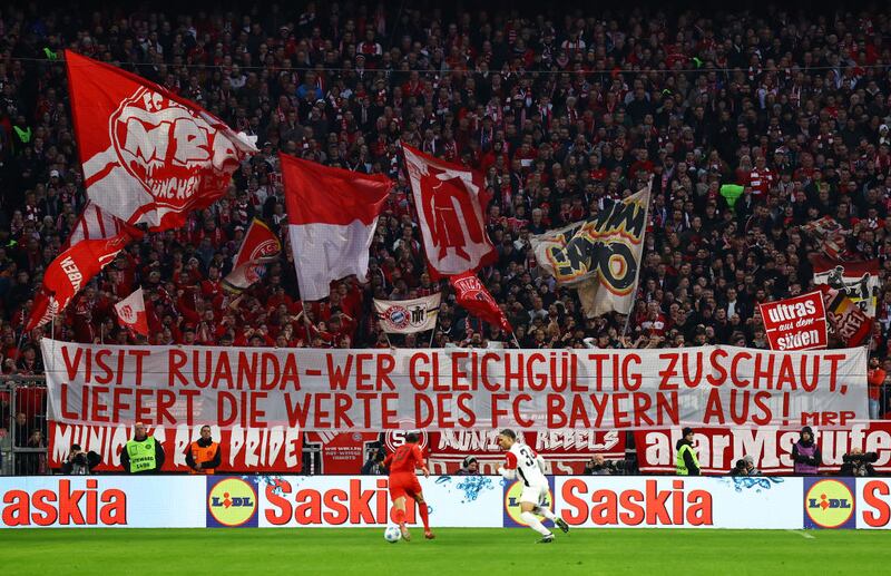 Fans of Bayern Munich hold up a banner in protest of their clubs partnership with Visit Rwanda