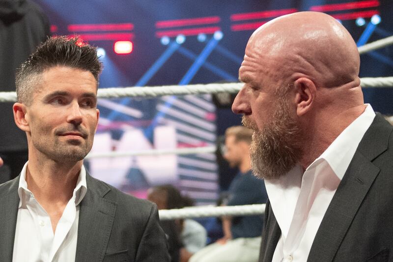 WWE's Chris Legentil works on talent moves that carry out the storyline vision of Paul "Triple H" Levesque (right).