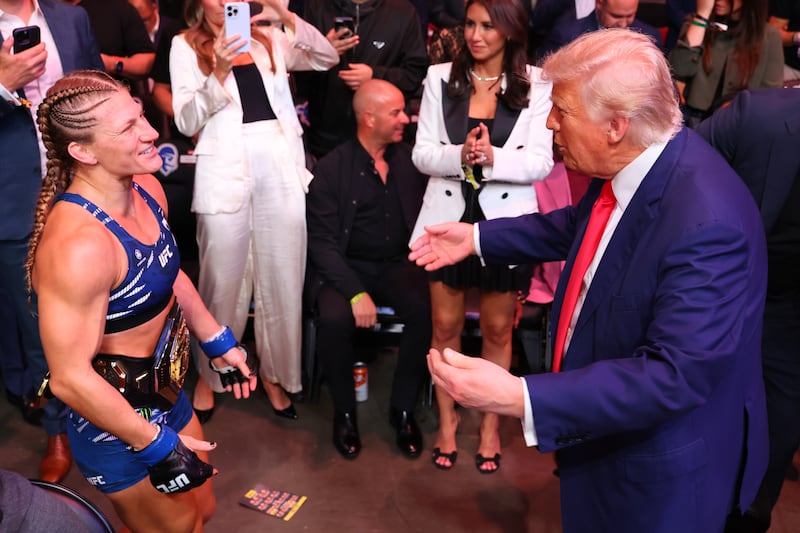 NEWARK, NEW JERSEY - JUNE 07: Kayla Harrison celebrates with U.S. President Donald Trump after her victory against Julianna Pena in the UFC women's bantamweight championship bout during the UFC 316 event at Prudential Center on June 07, 2025 in Newark, New Jersey. (Photo by Ed Mulholland/Zuffa LLC)
