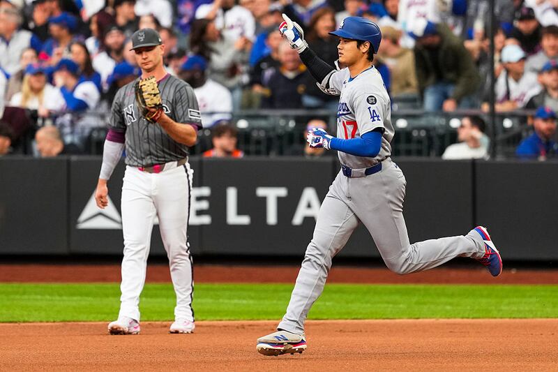 Shohei Ohtani #17 of the Los Angeles Dodgers rounds the bases after hitting a solo home run