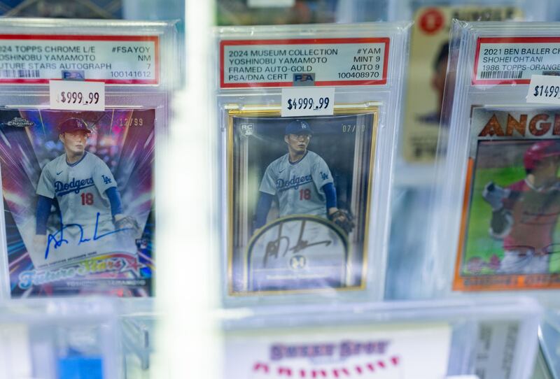 City of Industry, CA - November 29: Various signed Professional Sports Authenticator graded cards of Dodger's pitcher Yoshinobu Yamaoto on display for sale in the Gemini Sports Card & Memorabilia booth at Frank and Son's Collectable Show on Saturday, Nov. 29, 2025 in City of Industry, CA. (Photo by Ronaldo Bolaños/Los Angeles Times via Getty Images)