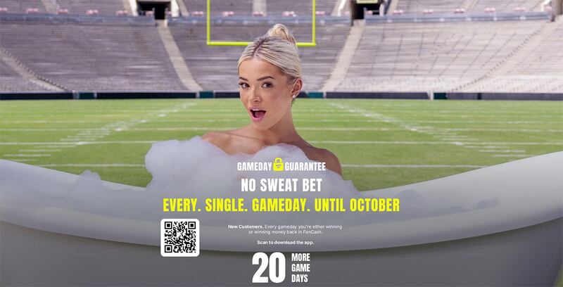 A woman is in a bathtub with soap suds on a football field